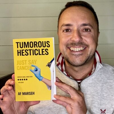Af Marseh holding his book Tumorous Hesticles
